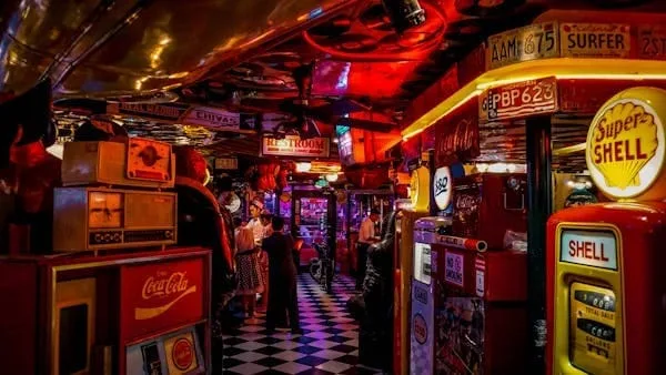 A bar with many different types of drinks on the counter.