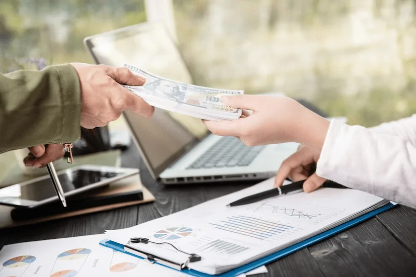 A person is handing money to another person.