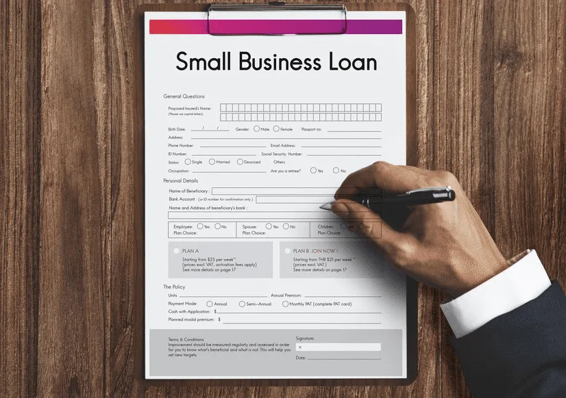 A person filling out a small business loan application.
