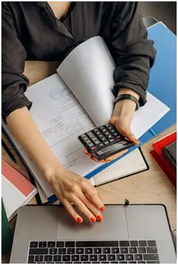 Business equipment financing papers and a calculator on a desk