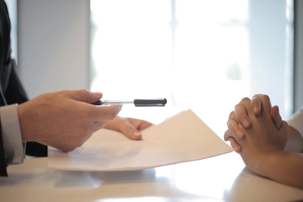 Medical business owner signing a loan contract with a financial advisor