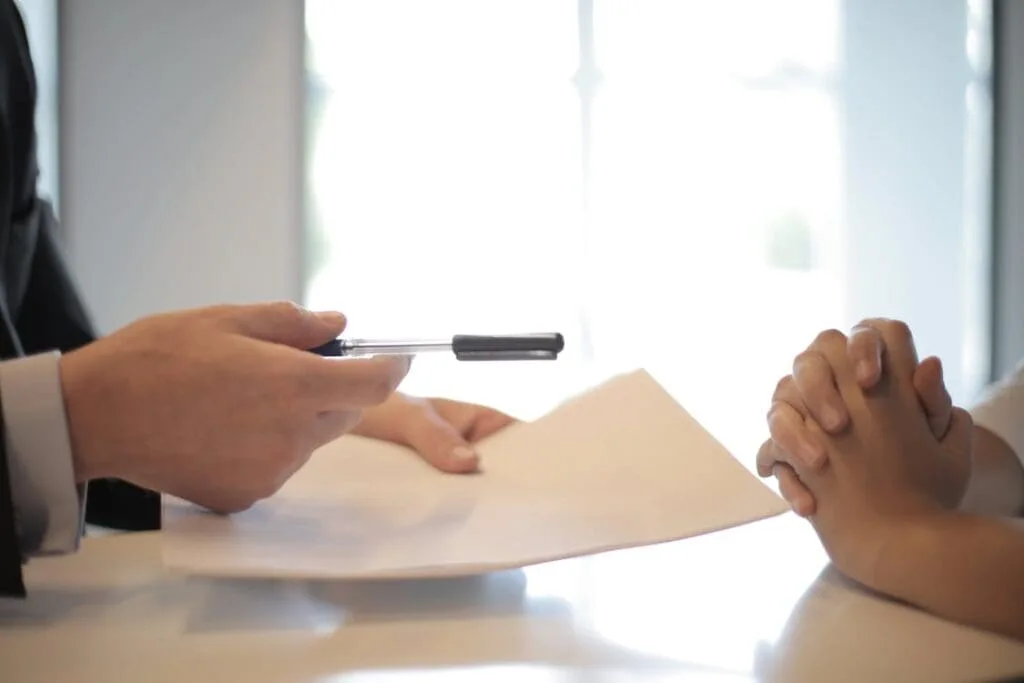 Medical business owner signing a loan contract with a financial advisor