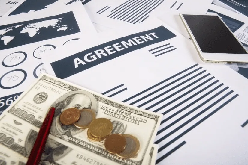 A close up of money and papers on top of a table