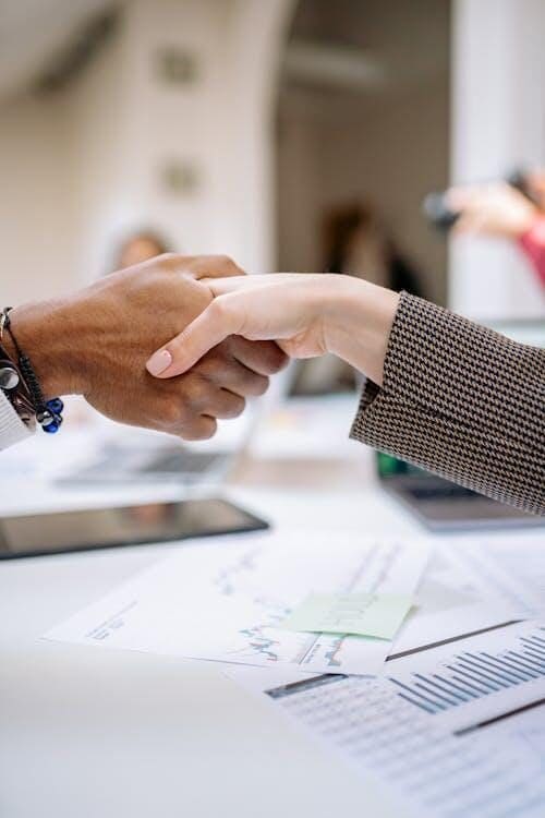 Close-up of a handshake between two people, symbolizing the successful acquisition of a loan