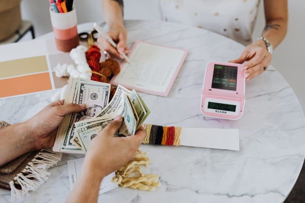 Various documents and a calculator on a desk representing small business loans