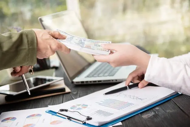 A person handing over cash