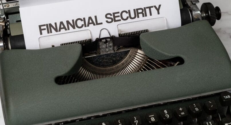 A close-up of a typewriter with a ‘financial security’ sign on it.
