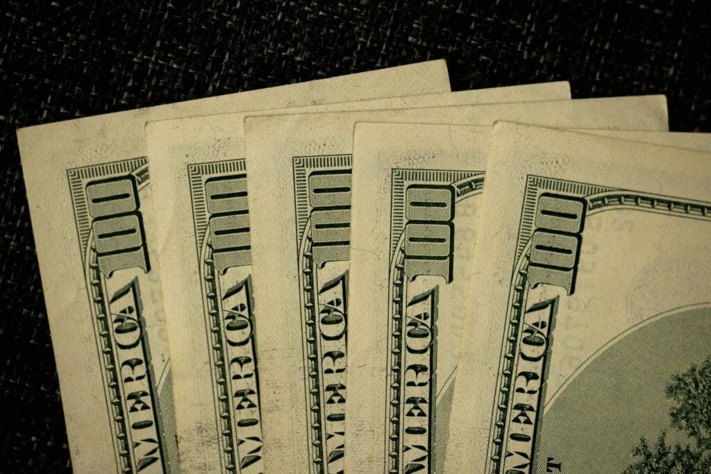 Close-up of several one hundred dollar bills fanned out, symbolizing working capital and flexible financing for growing businesses.