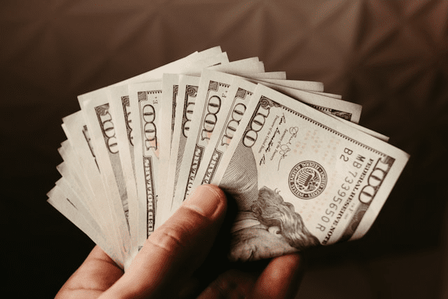 Hand holding a stack of cash