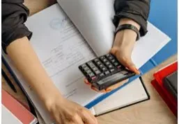 Business equipment financing papers and a calculator on a desk