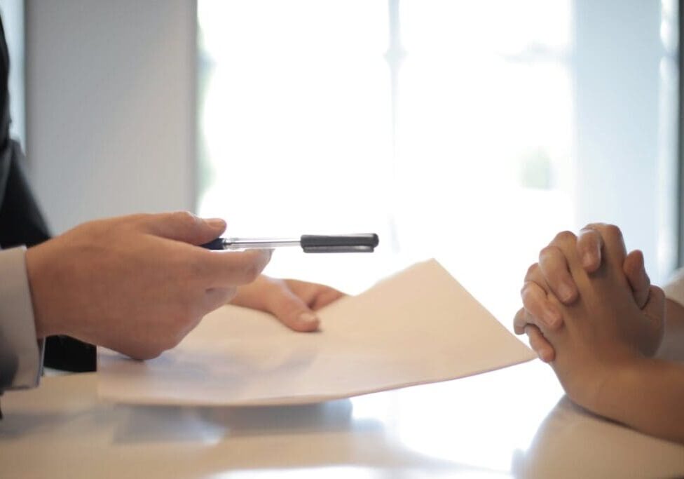 Medical business owner signing a loan contract with a financial advisor