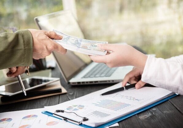 A person handing over cash