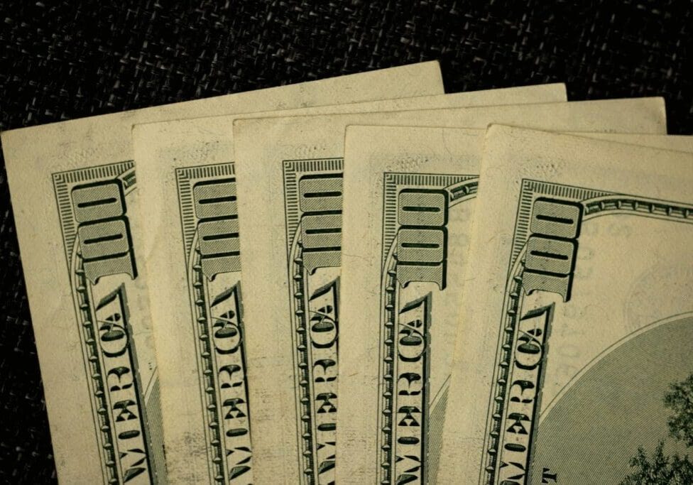 Close-up of several one hundred dollar bills fanned out, symbolizing working capital and flexible financing for growing businesses.