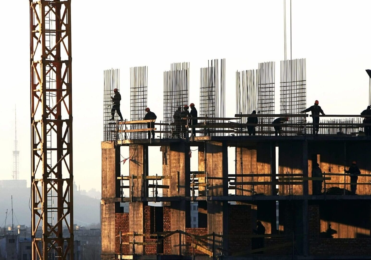 A group of people standing on top of a building.
