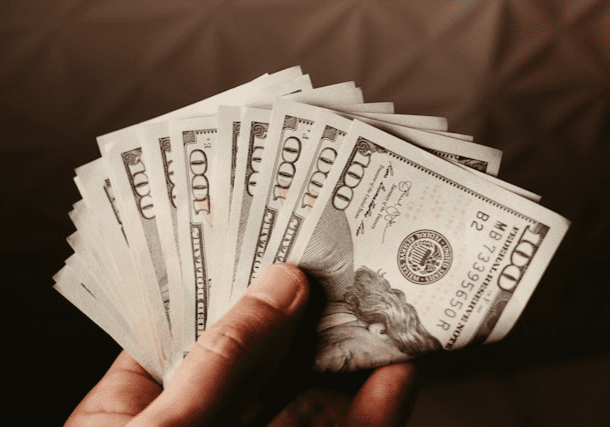 Hand holding a stack of cash