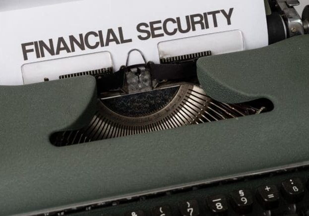 A close-up of a typewriter with a ‘financial security’ sign on it.