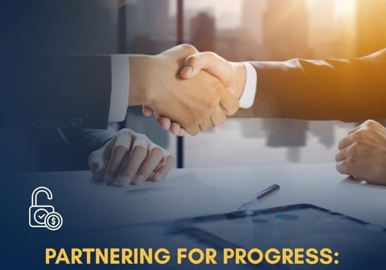 Business professionals shaking hands over paperwork and charts, symbolizing a successful agreement on construction loans and financial partnership